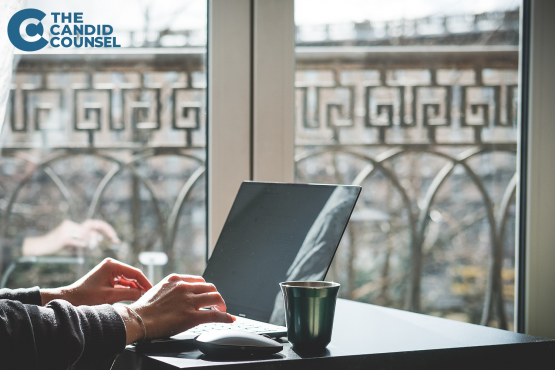 Woman sitting on patio working on laptop