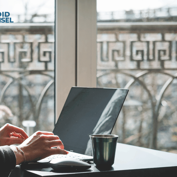 Woman sitting on patio working on laptop